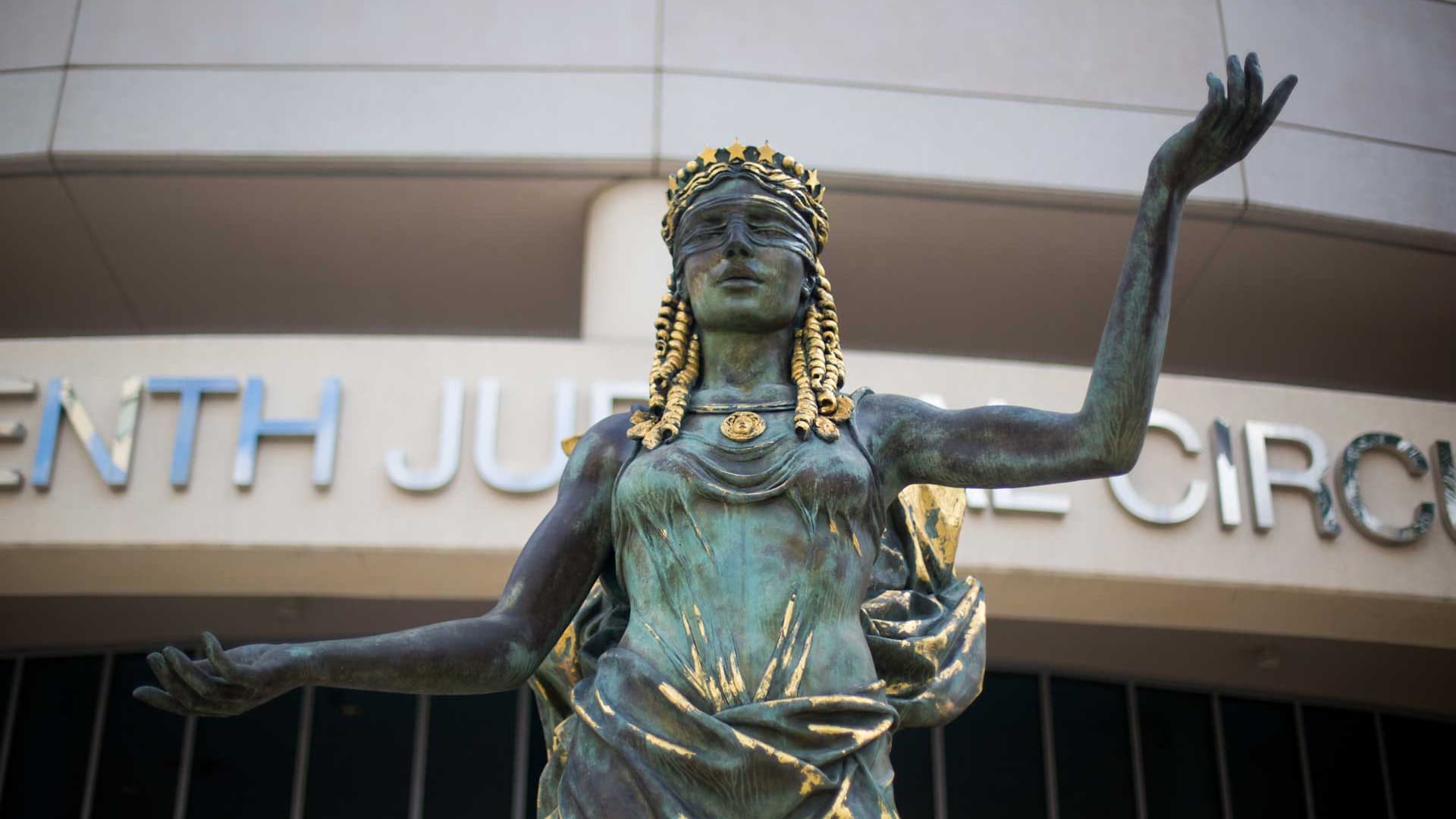 The scales-of-justice statue outside the Thirteenth Judicial Circuit courthouse