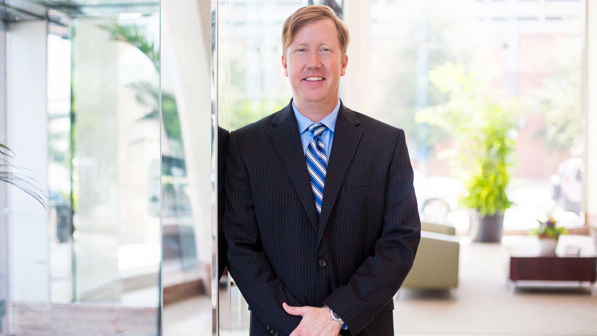 Scott Haas standing in the firm's Tampa office